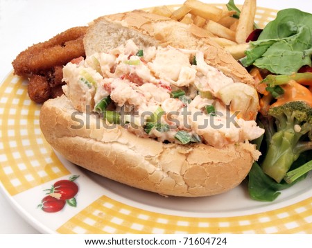 a new england style lobster roll sandwich meal with sides of french fries, onion ring, and salad on a white background with copy space
