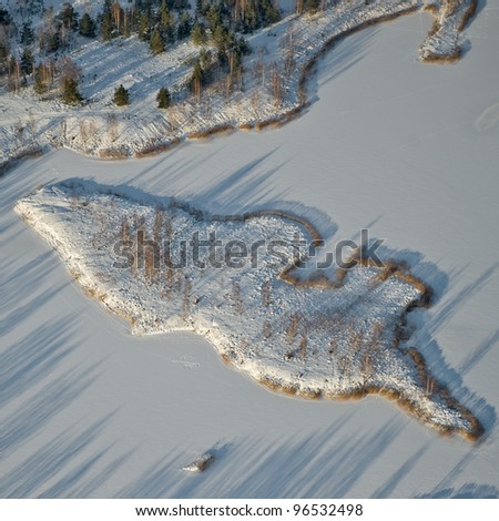 aerial view small snowy island in the lake