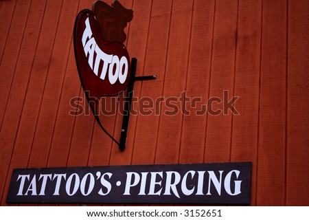 Sign hanging from tattoo parlor in 