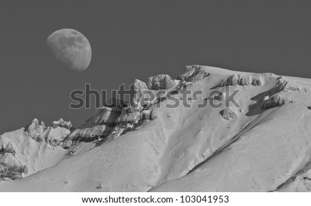 Big moon and snow covered mountains, black and white composition
