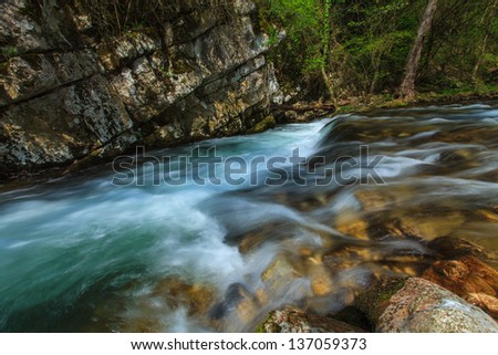 Pristine silky stream and waterfalls in limestone mountains in spring