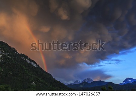 Evening storm, rainbow and clouds in the mountains