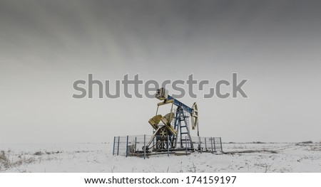 Operating oil and gas well isolated on white and grey background