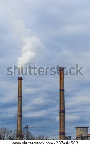Industrial scenery with coal powered plant stacks and smoke