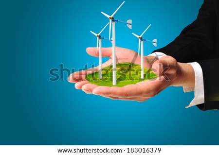 Hand of Business Man hold Turbine Power Generator as renewable energy concept
