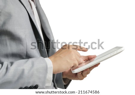 Asian business man using digital tablet computer against a white wall with clipping path