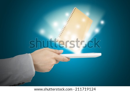 Hand Holding touch screen tablet and Books as e-book and e-document concept