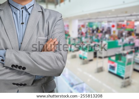 Business Man stand in Hypermarket or Supermarket store present retail marketing