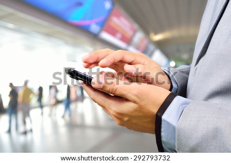 Business Man using Mobile Phone in Modern Train Station or Subway station
