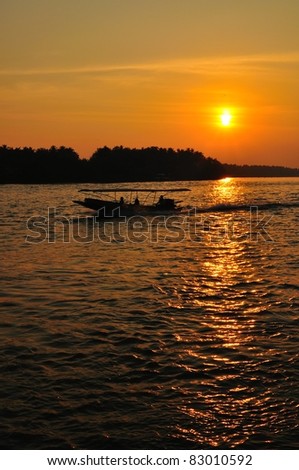 silhouette of speed boat running in the river of Bangpakong, Ampawa, Thailand.