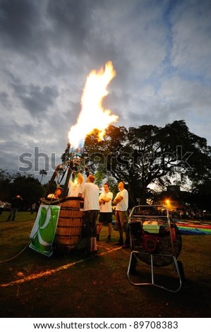 CHIANG MAI - NOV 25: Unidentified pilot testing burner of Hot air balloon during Thailand balloon festival 2011 at Prince Royal college in Chiangmai, Thailand on Nov 25, 2011.