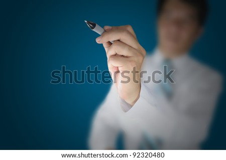 Business man writing touch screen PC on white background