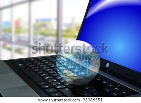 crystal Earth globe on keyboard of laptop or notebook computer