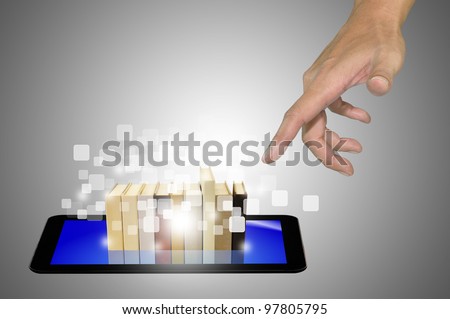 Hand reaching Stack of Book over Touch Screen Tablet PC in E-book concept