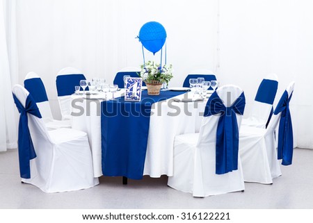 Beautiful wedding chair and table setting for fine dining in blue and white color