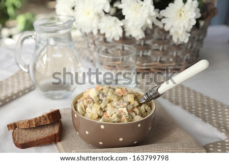 Russian salad on rye bread. Festive table setting. Olivier. Winter salad.
