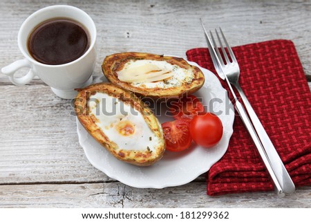Baked potatoes with egg. Quick original breakfast. Food style.