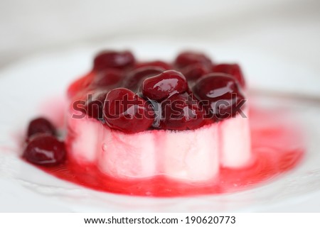 Layered dessert with fruits, cream cheese in glass jar, selective focus. Panna Cotta. Milk jelly and fruit jelly berries cherries. Food style.