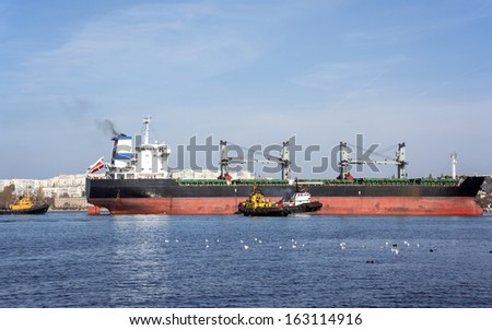 Empty bulk carrier cargo ship with deck cranes