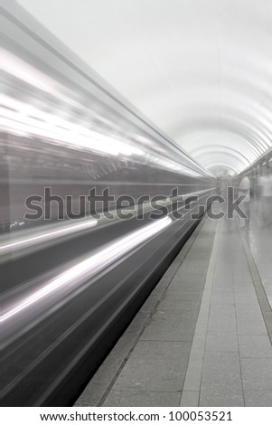 Motion in subway. background of a rapidly moving train subway and people waiting for him.