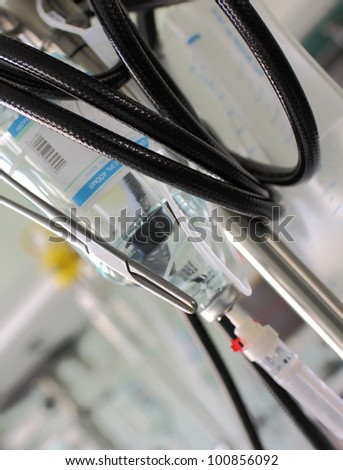 Metal clamp, tube, vials, dropper. Abstract medical background.