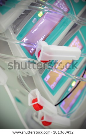 Elements of intravenous systems on a background device. Medical technology and its application in the work.