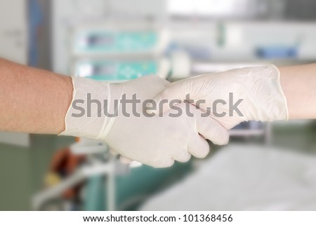 handshake in the hospital. Greeting two medical workers. Photo.