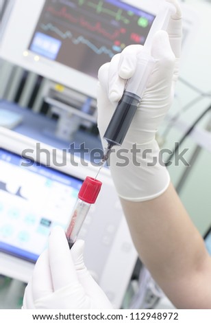 blood in the syringe and test tube for laboratory analysis. action at the bedside in the intensive care unit.