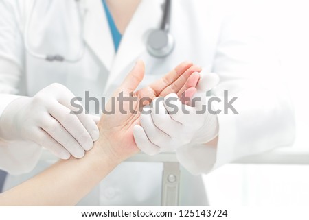 Hands of the patient and the doctor