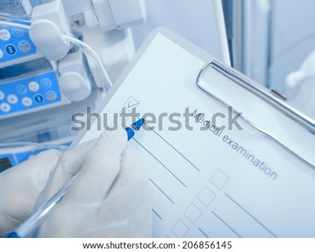 Medical examination. Doctor with a checklist on clipboard in the clinic