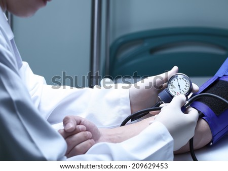 Doctor and patient. Measurement of blood pressure in a hospital