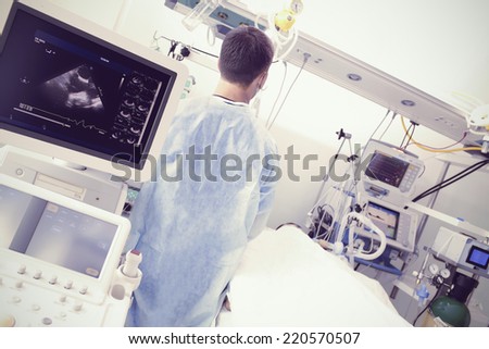 Doctor in the hospital ward surrounded by modern diagnostic and treatment equipment