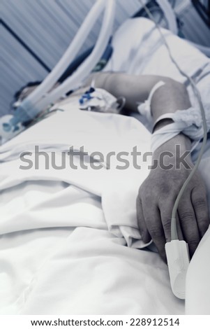 Patient in a bad state lying in his bed in the ward