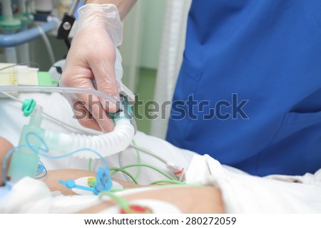 Doctor works with patient in the intensive care unit ward