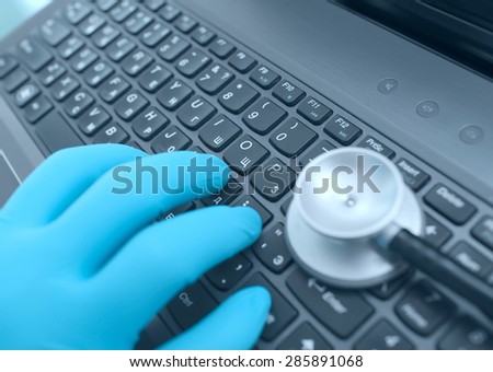Doctor\'s hands on the keyboard while working in the hospital macro