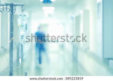 Medical drip in the blurred background of doctors.