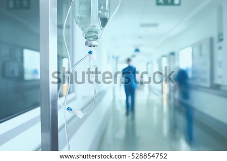Silhouette of a doctor walking in a hurry in the hospital corridor.