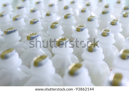 Plastic medical bottles with a liquid , standing in neat rows. Photo