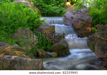 Cascading Multi-Level Waterfall Shot At Slow Shutter Speed To Produce Motion Blur Silky Water Effect.