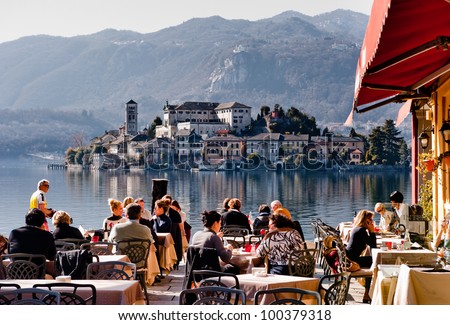 http://image.shutterstock.com/display_pic_with_logo/595720/100379318/stock-photo-lake-orta-italy-feb-people-in-a-restaurant-in-orta-on-february-with-the-nearby-100379318.jpg