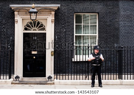 LONDON, UK - JUN 16: A  police officer guards the door of 10 Downing Street in London on June 16, 2013 as British PM David Cameron meets Russian President Vladimir Putin to discuss Syria ahead of G8.
