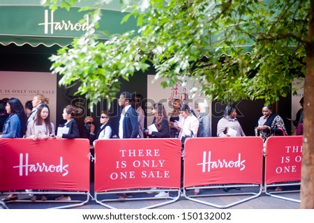 LONDON, UK - JUN 15: customers queue outside the Harrods store in London on June 15, 2013 for the opening of the summer sales.