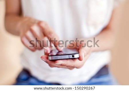 Young woman using a touchscreen smartphone.