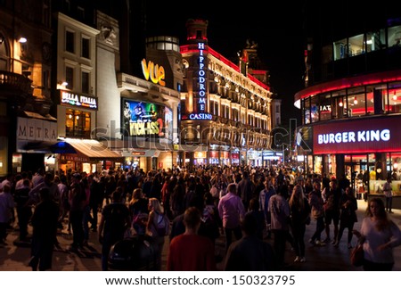 LONDON, UK - AUG 16: people enjoy the nightlife in Leicester Sq in London on August 16, 2013. Leicester Sq is the prime location in London for cinemas and world leading film premiers.