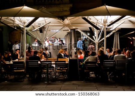 LONDON, UK - AUG 16: People enjoy dinner in a restaurant in Covent Garden in London on August 16, 2013. The Covent Garden area has over 60 restaurants and bars and is a popular night destination