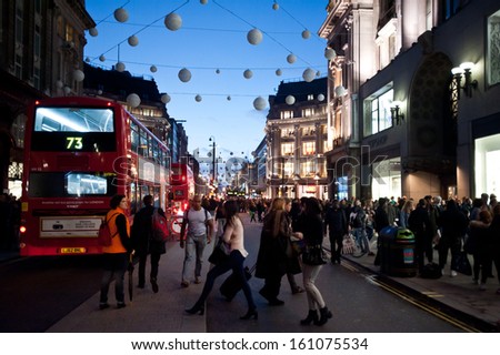 LONDON, UK - NOV 2: People stroll in Oxford Circus in London on November 2, 2013. The intersection between Oxford Street and Regent\'s Street is the main shopping center within Inner London.