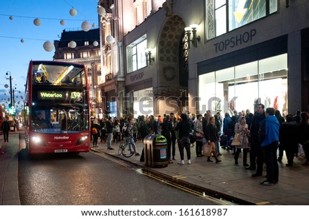 LONDON, UK - NOV 2: People stroll on a Saturday in Oxford Circus in London on November 2, 2013. The intersection between Oxford St and Regent\'s St is the main shopping center within Inner London.