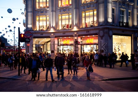 LONDON, UK - NOV 2: People stroll in Oxford Circus in London on November 2, 2013. The intersection between Oxford Street and Regent\'s Street is the main shopping center within Inner London.