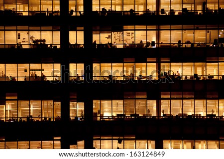 LONDON - NOV 1: people work in an office building in London on November 1, 2013. Full-time employees in the UK work longer hours than the EU average, according to the Office for National Statistics.