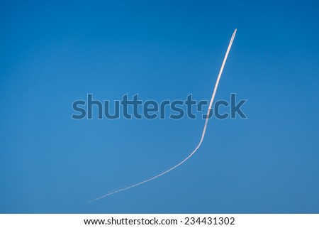 Airplane goes up in blue sky leaving a growing contrail. Concept of way to success, growth, progress, improvement.